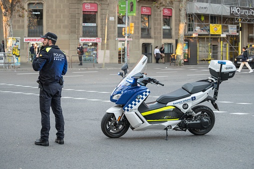 A rear view shot of an unrecognisable mature black man wearing formal businesswear and a helmet on a summers day in a city. He is riding bicycle as he sustainably commutes to work.