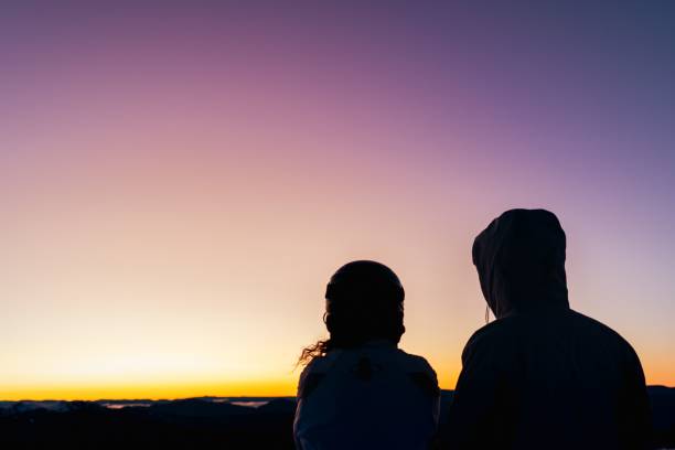istock Couple's silhouette enjoying the sunset together 1492795457