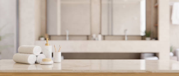 istock Copy space on a white tabletop with toiletries in a modern white bathroom with double sink. 1492797879
