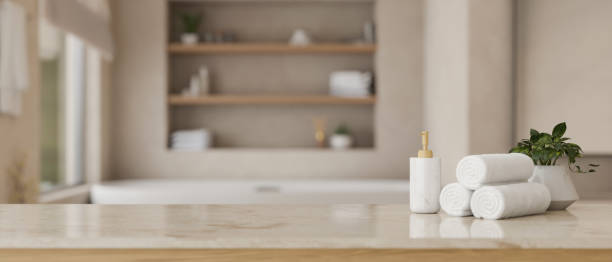 istock Towels, shampoo bottle, potted plant and copy space on a tabletop 1492797880