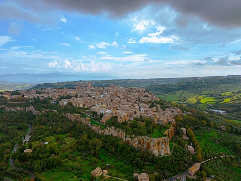 An aerial view of the Italian city of Orvieto, located on a lush green hillside
