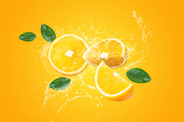 istock Creative layout made from Fresh Sliced orange fruit and water Splashing on a orange background. 1492799234