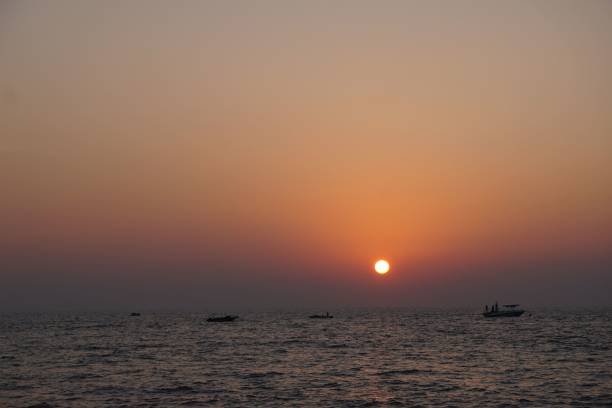 istock the sun is setting over the ocean as seen from the pier 1492799940