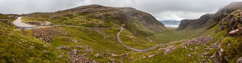 A scenic Bealach na Ba road winding through the mountains in Scotland