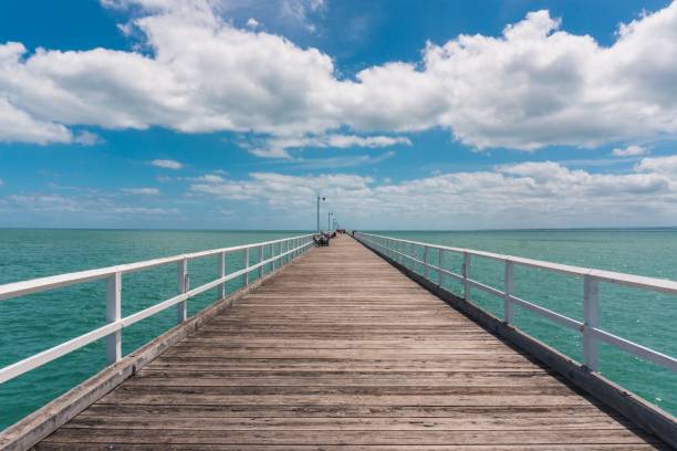 istock Wooden platform extending into a tranquil, sun-lit sea 1492801476