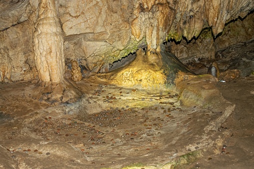 An awe-inspiring scene of a mysterious rocky cave featuring stunning mineral formations