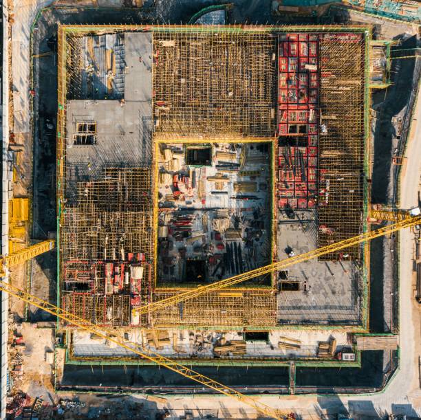 istock a yellow crane is sitting in front of a construction area 1492802650