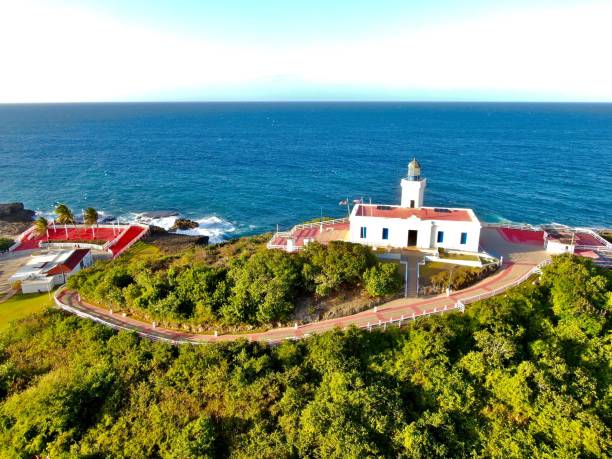 istock Majestic lighthouse on a rocky shore, set against a backdrop of tranquil blue waters 1492803131