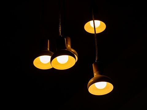 A close-up view of a collection of light bulbs glowing brightly against a dark background