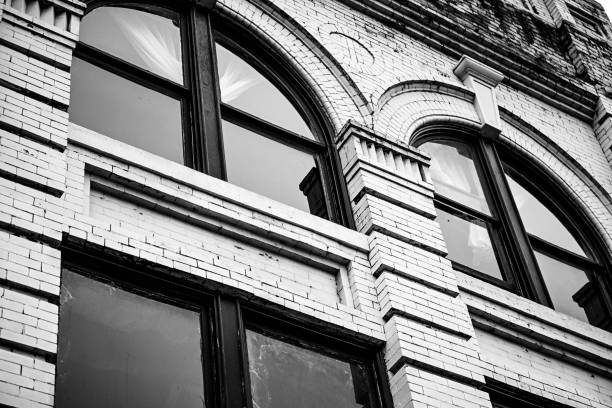 An old brick building exterior in grayscale