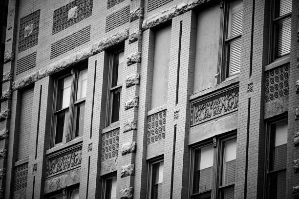 An old brick building exterior in grayscale