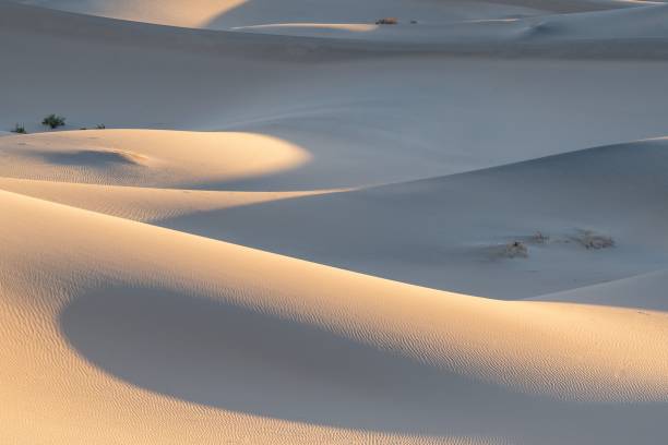 Beautiful view of desert landscape showcasing flat sand, sunset hues reflected on its surface