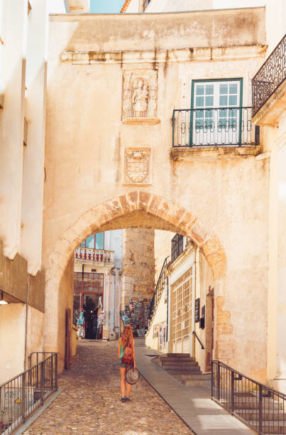 Coimbra street city- Woman tourist walking in old town in Portugal Coimbra street city- Woman tourist walking in old town in Portugal coimbra city stock pictures, royalty-free photos & images