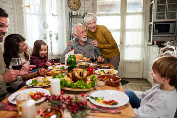istock Happy extended family talking during lunch in dining room. 1492807634