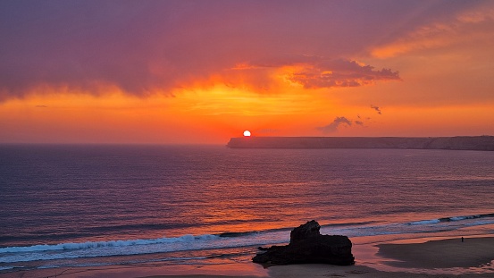 A breathtaking image of a picturesque sunset over a sandy beach, Sagres