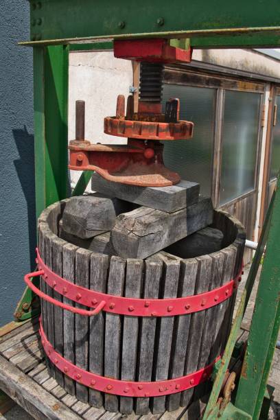 A vintage fruit press machine, aged to perfection with antique rustic charm