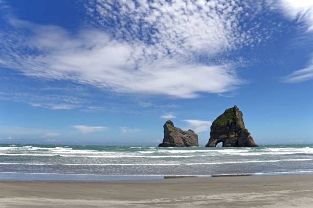 istock two large rocks standing out into the water near the beach 1492810721
