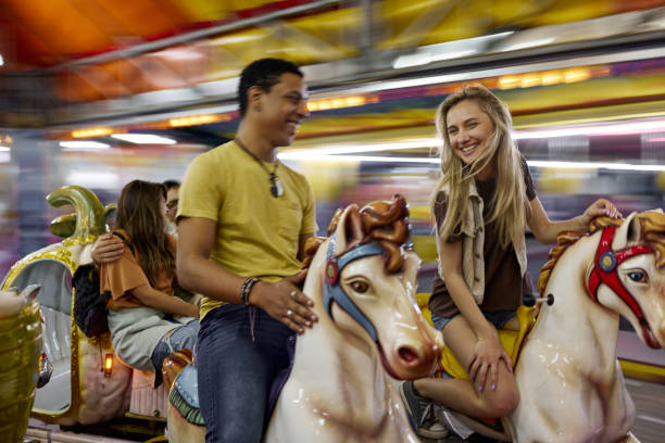 istock Merry-go-round carousel ride in blurred motion at amusement park! 1492811281