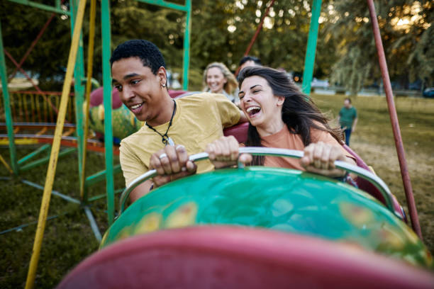 istock Young happy couple having fun on rollercoaster at amusement park. 1492811339