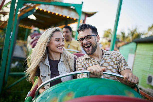 istock Cheerful couple having fun on rollercoaster at amusement park. 1492812815