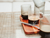 Glass coffee cups outdoors on table with lungo expresso measurement