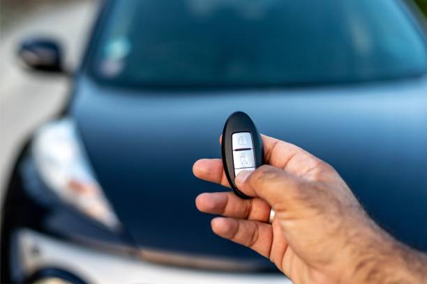istock A person holding a keyless car remote in his hand by pressing the unlock button. selective focus with blurred background 1492815566