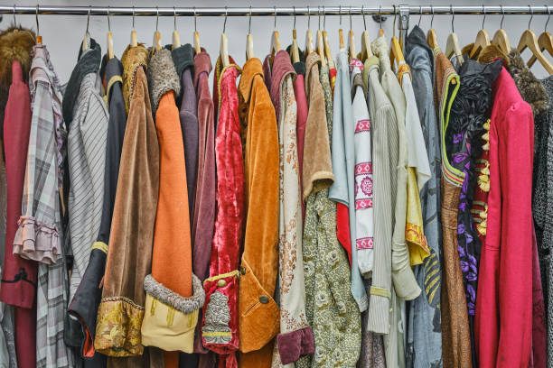 Vintage theatrical clothes in dressing room. Old theatrical costumes hanging on rod in row in dressing room. Movie vintage clothes, props. stage costume stock pictures, royalty-free photos & images