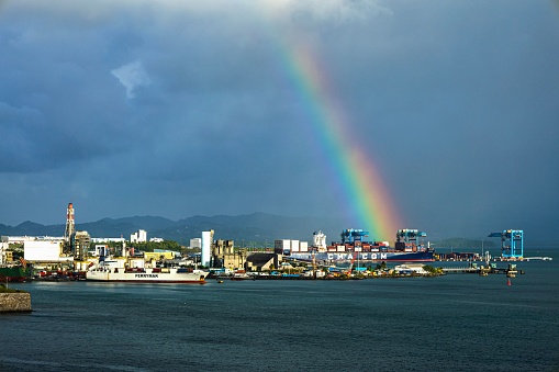 Fort De France, Antigua and Barbuda – January 02, 2023: A vibrant rainbow spanning across the sky over the scenic shoreline of Fort De France.