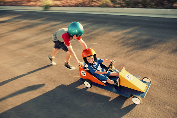 Need for Speed A young racing duo hits the road in their pursuit of conquering speed. soapbox cart stock pictures, royalty-free photos & images