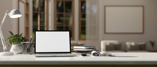 istock Close-up home workspace with laptop mockup and decor on a white tabletop 1492821852