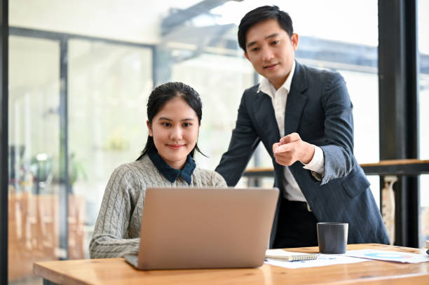 istock A young Asian female marketing assistant working on a new project with her boss 1492822095