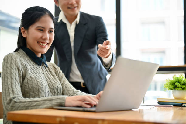 istock An attractive Asian female assistant is working on her work on a laptop while her boss is briefing. 1492822103