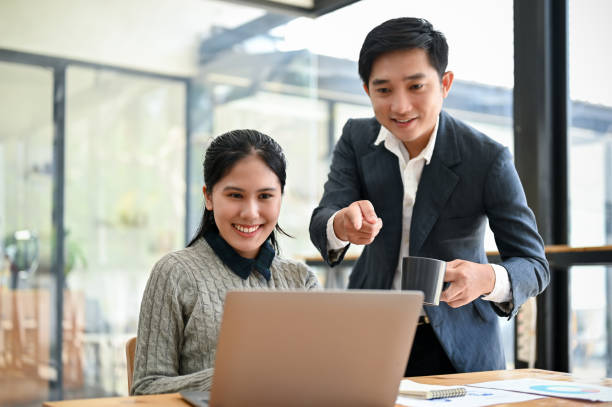 istock A young Asian female marketing assistant working on a new project with her boss 1492822126