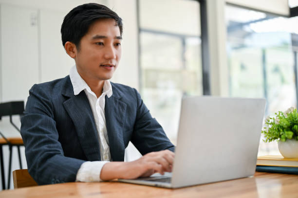 istock A smart Asian businessman using his laptop computer, managing his work 1492822297