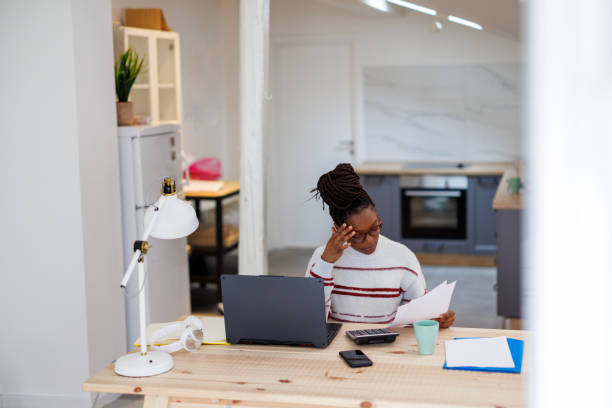 istock An African woman is working from home analyzing business activities. 1492823993