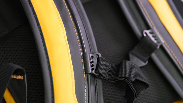 istock Shoulder straps in yellow and black backpack for comfortable carrying on back closeup 1492824359