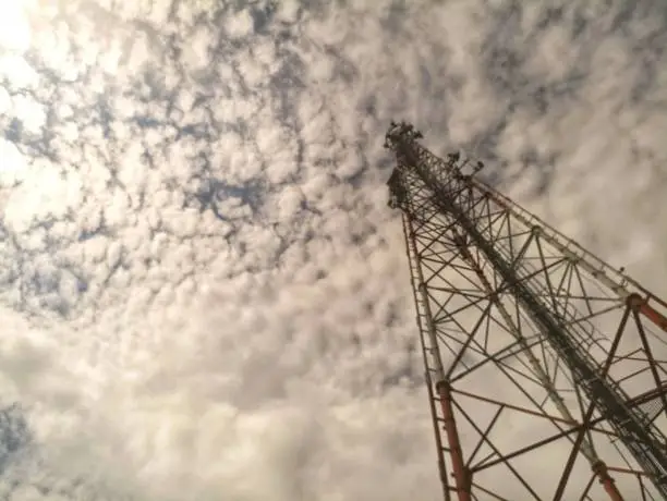 the tower under the cloud will be exposed to sunlight when it is sunny