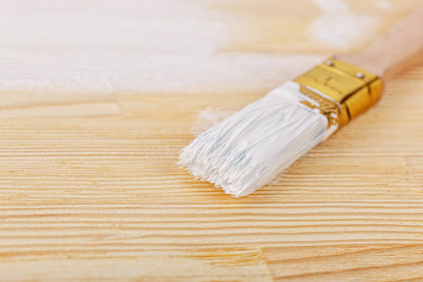 istock white paint with a brush on a wooden background with texture 1492826287