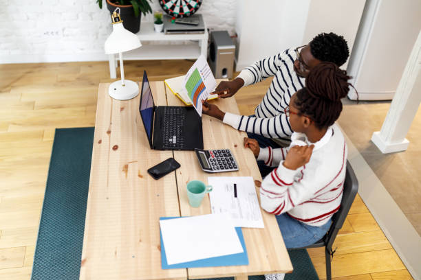 istock An African man is working from home analyzing business activities with his female African friend. 1492826465