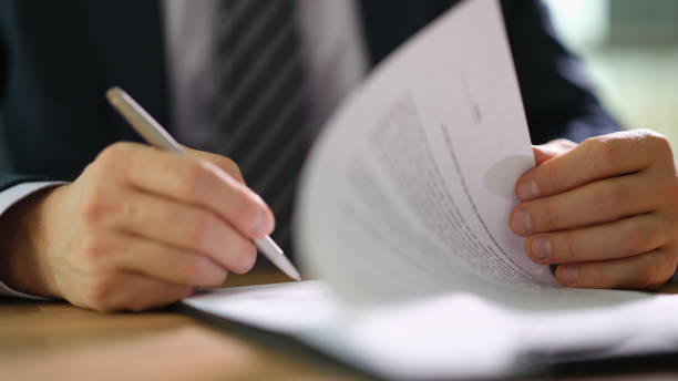 istock Businessman in suit signing and officially certificating important document closeup 1492827189