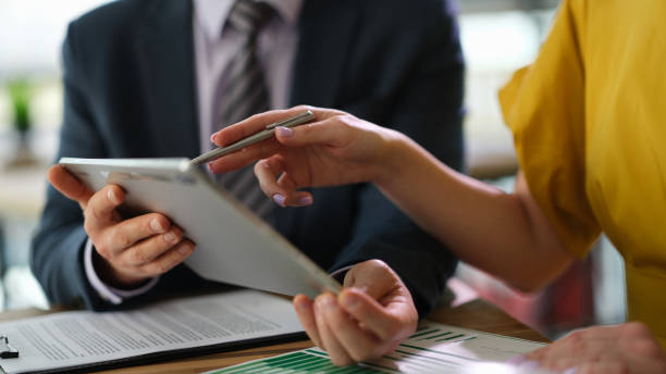 istock Business colleagues studying information on digital tablet while meeting in office closeup 1492827195