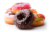 A pile of glazed doughnuts with sprinkles