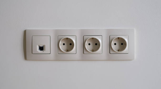 istock White sockets with wi fi entrance on wall closeup 1492830344