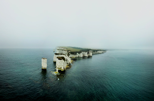 Old Harry Rocks are three chalk formations, including a stack and a stump, located at Handfast Point, on the Isle of Purbeck in Dorset, southern England. They mark the most eastern point of the Jurassic Coast, a UNESCO World Heritage Site.