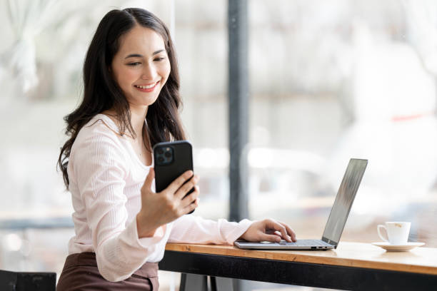 istock Smiling young businesswoman using smart phone sitting at home office 1492833413