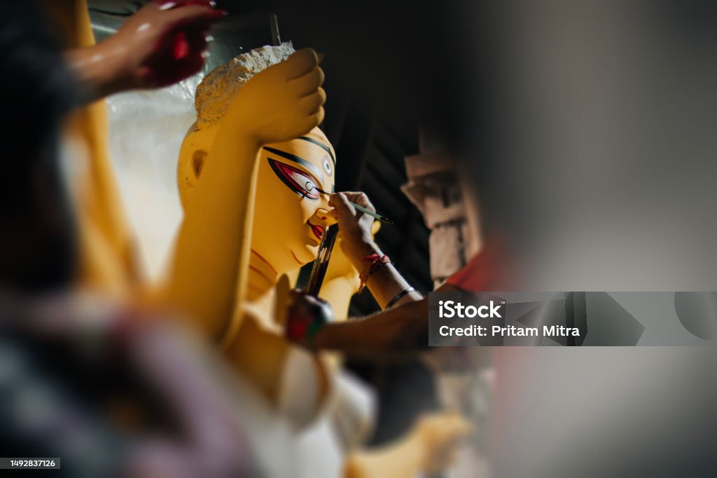 Durga idol eye making by a man closeup stock photo Durga Stock Photo