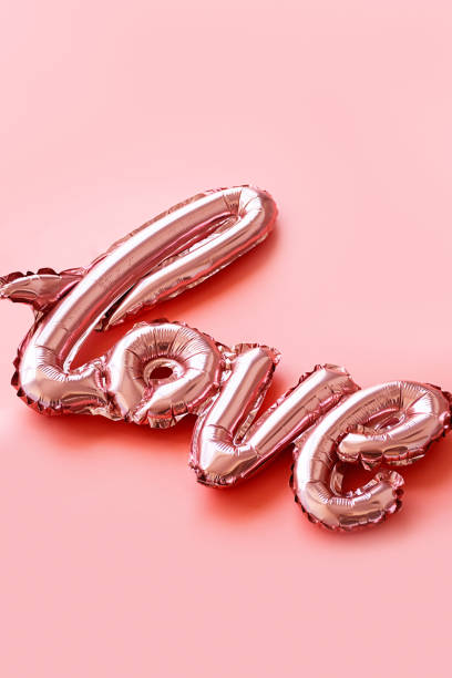 istock Love made from foil balloons on pink. Monochrome image. 1492838788