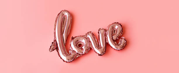 istock Love made from foil balloons on pink. Monochrome image. 1492838789
