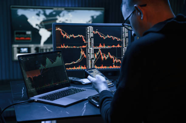 istock Rear view. Male professional hacker is sitting by computer, conception of virus 1492839181