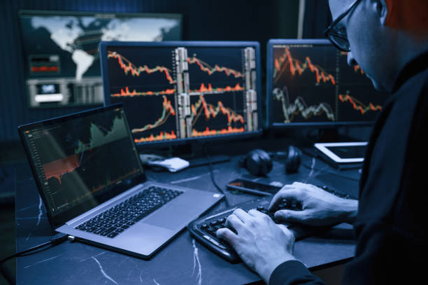 istock Using laptop. Male professional hacker is sitting by computer, conception of virus 1492839254
